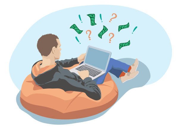 a young man sits in an armchair and works at a computer.