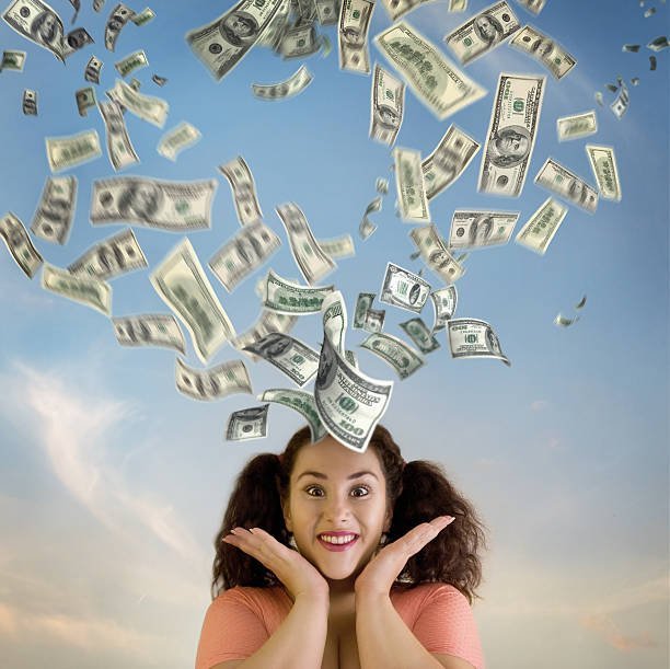 happy young woman and money falling from the sky.